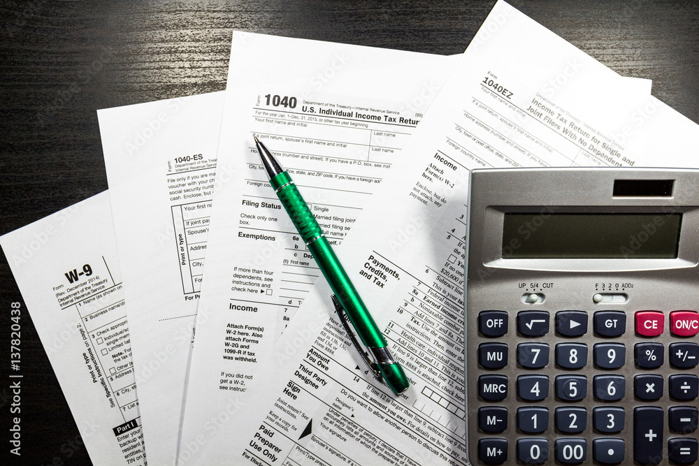 US tax form 1040 with pen and calculator. Tax form law document, business concept US tax form 1040 with pen and calculator. Tax form law document, business concept