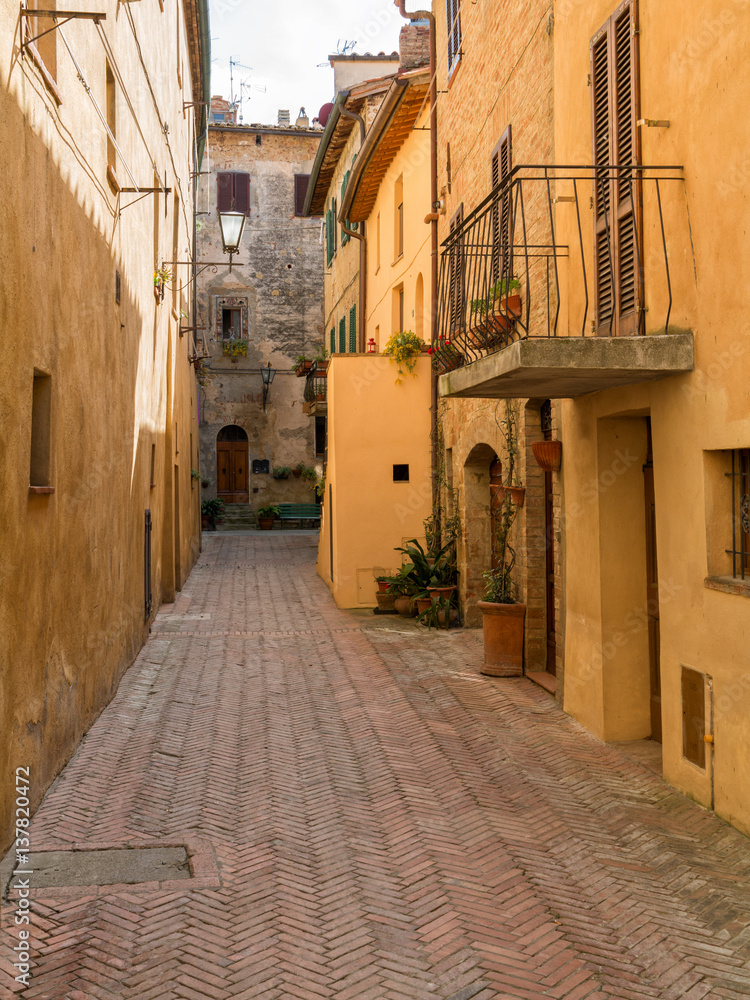 Beautiful narrow alley with traditional historic houses at Montepulciano city