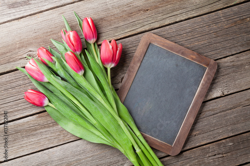 Red tulips bouquet and chalkboard