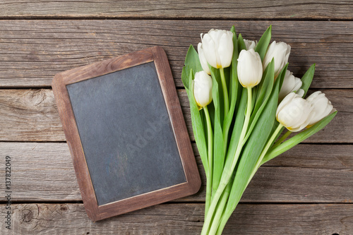 White tulips bouquet and chalkboard