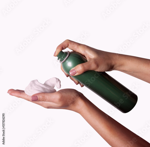 Close-up of hairdresser hairstylist female hand with hair mousse spray.