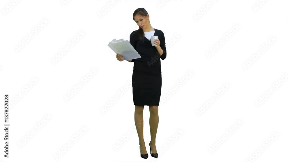 Young businesswoman reading documents while drinking coffee on white background Young businesswoman reading documents while drinking coffee on white background