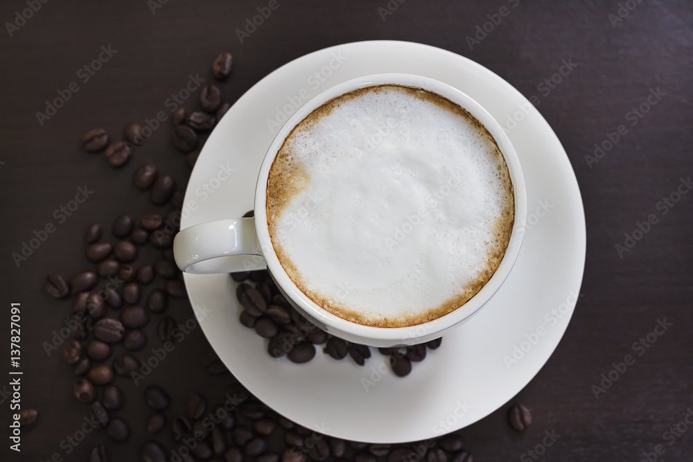 Hot coffee in a white cup on the table. Hot coffee in a white cup on the table.