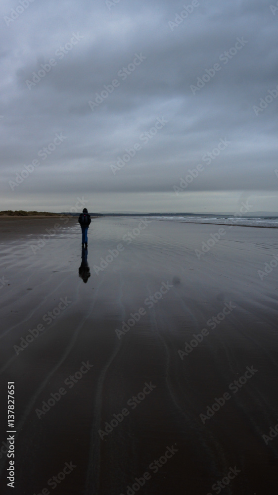 Single Person walking at beach
