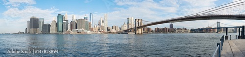 New York city skyline panorama and Brooklyn Bridge in a sunny day