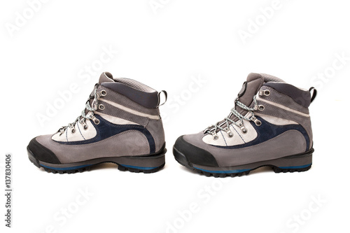Hiking high boots isolated on white background © EdNurg