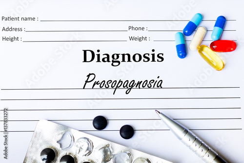 Prosopagnosia -  Diagnosis written on a piece of white paper with medication and Pills photo