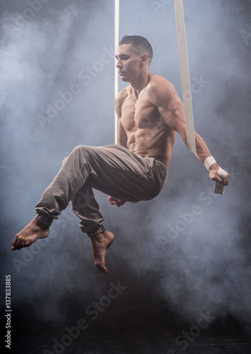 circus artist on the aerial straps man © Hladchenko Viktor
