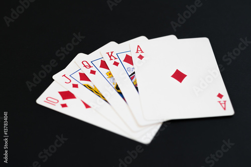 Royal Flush of diamonds in poker cards game on a black background