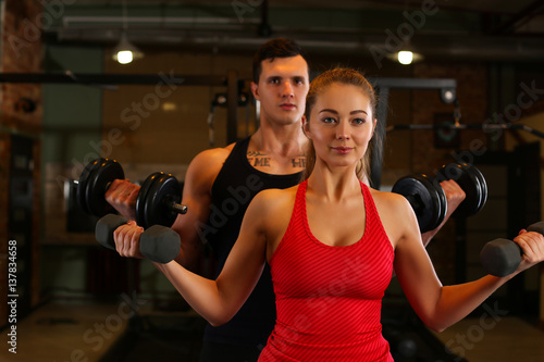 Sporty young smiling couple work out together