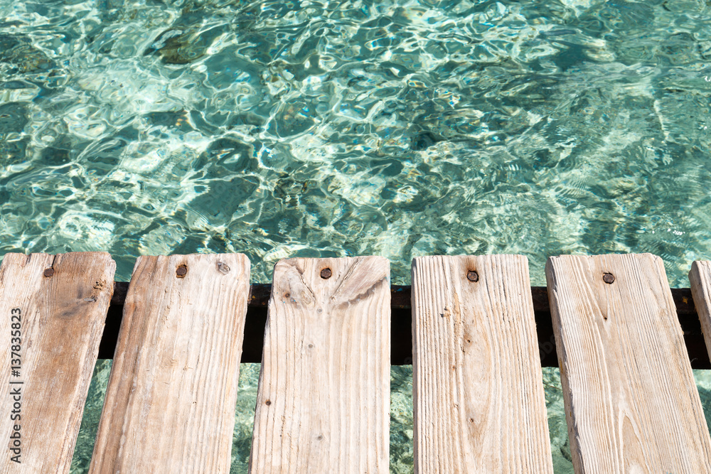 Red sea and old wooden platform Red sea and old wooden platform