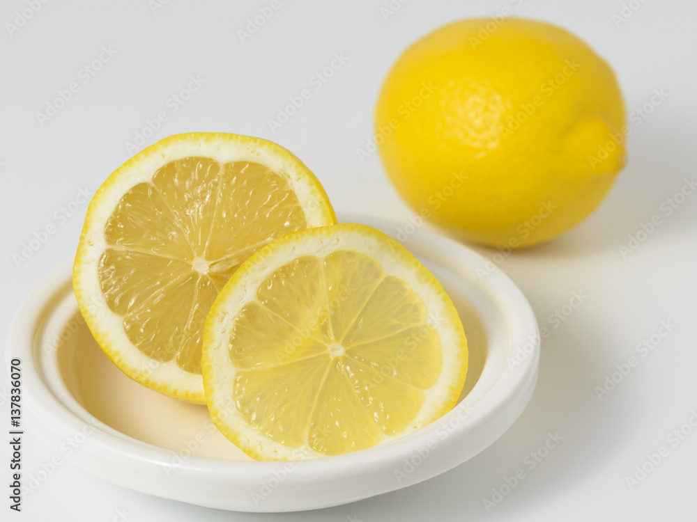 Lemons whole and sliced on a white background. Lemons whole and sliced on a white background.