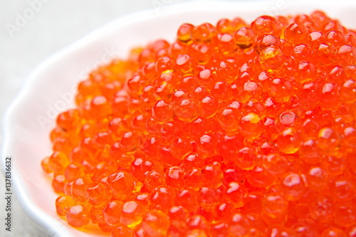 Red caviar of a salmon in a saucer.