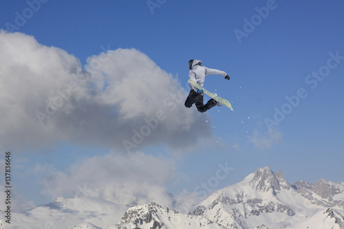 Snowboard rider jumping on mountains. Extreme snowboard sport. © Vasily Merkushev