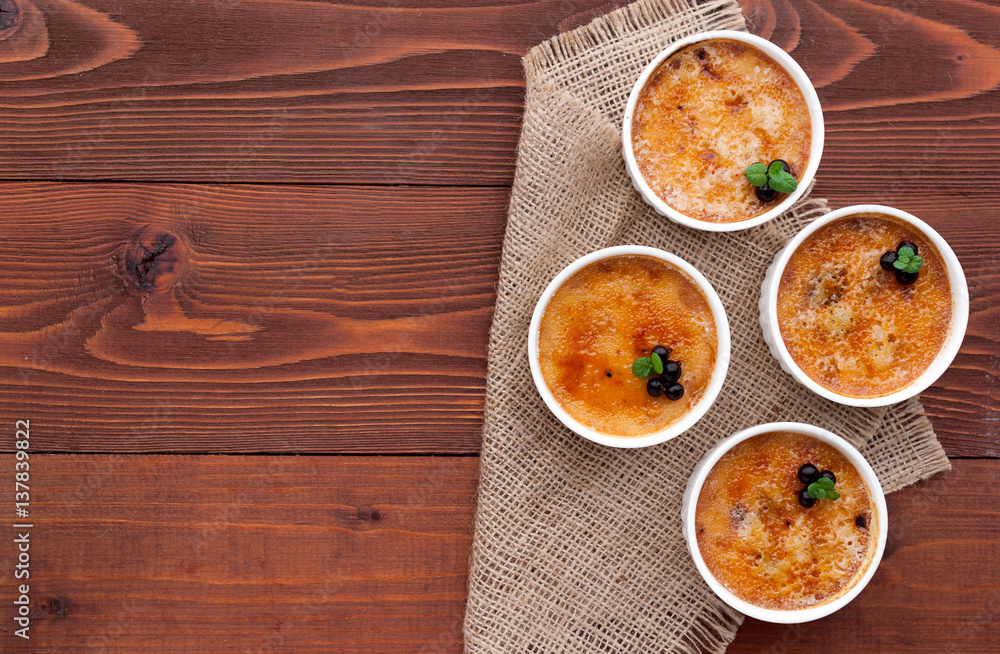 Creme brulee in a white bowl with sugar crust. Studio photography. country style. Creme brulee in a white bowl with sugar crust. Studio photography. country style.