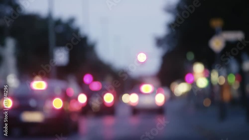 Blurred Drive Trip through an Evening City, Background Picture for Sadness Crime or Loneliness. Subjective view of a car into the blue city, the red, green and blue lights of the city become bokehs.