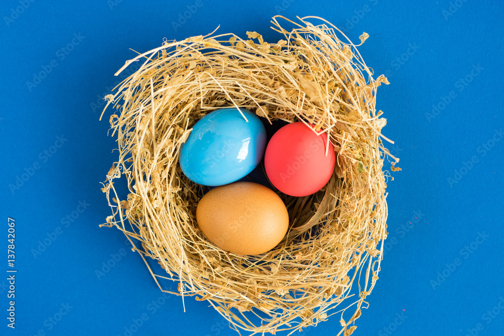 Easter eggs in nest on rustic wooden background, selective focus image. Happy Easter Card - space for text Easter eggs in nest on rustic wooden background, selective focus image. Happy Easter Card - space for text