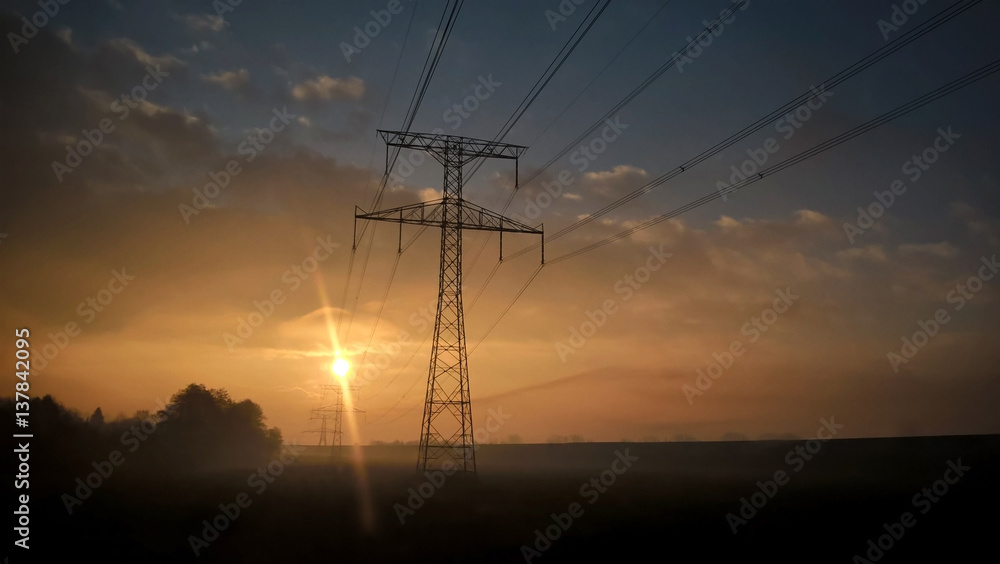 Electricity pylon during misty sunrise morning. Slovakia