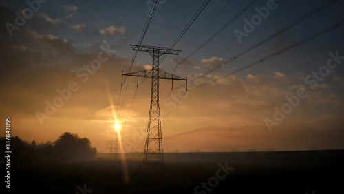 Electricity pylon during misty sunrise morning. Slovakia