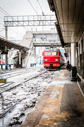 red train arriving at main station in Krasnoyarsk, Russia, trans-siberian railway. 