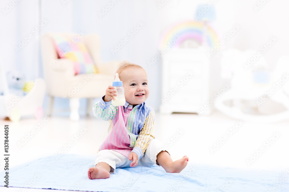 Baby boy with bottle drinking milk or formula Baby boy with bottle drinking milk or formula