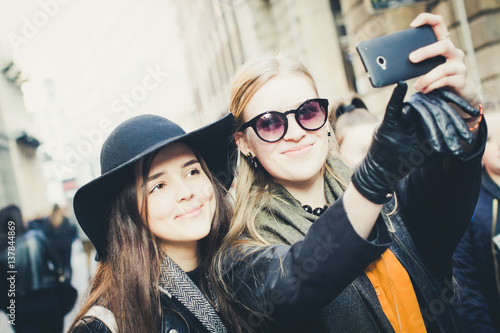 two pretty girls taking selfie