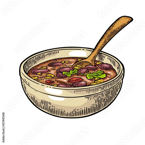 Chili con carne in bowl with spoon - mexican traditional food.