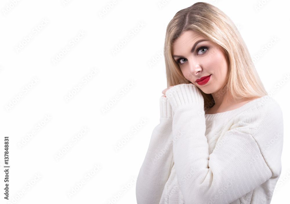 Beautiful young girl in a knitted sweater,has his hands under his chin looking at the camera. Beautiful young girl in a knitted sweater,has his hands under his chin looking at the camera.