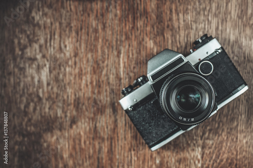 Retro camera on wooden table