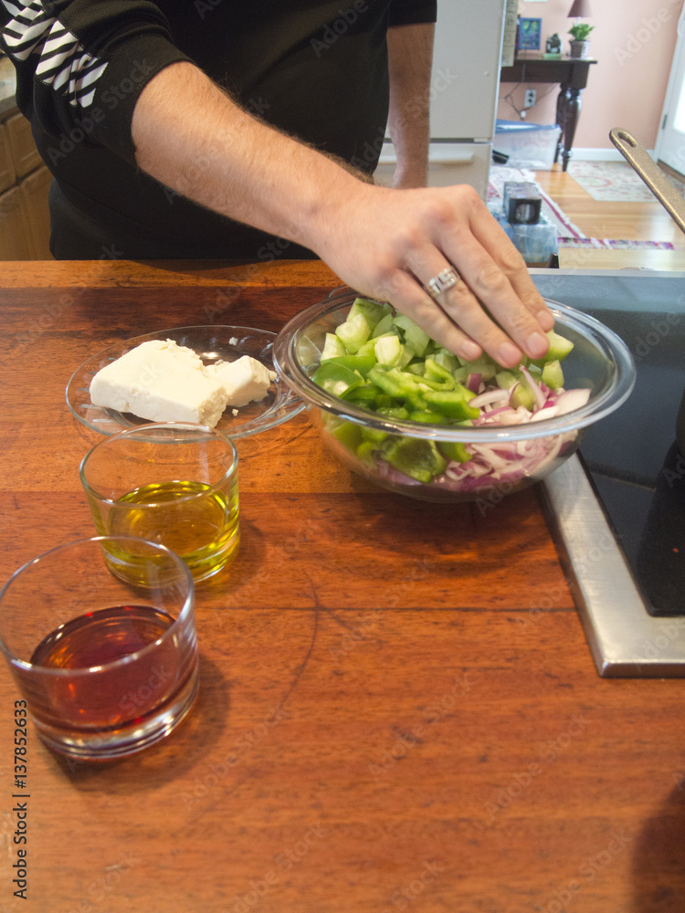 Man Preparing a Greek Salad