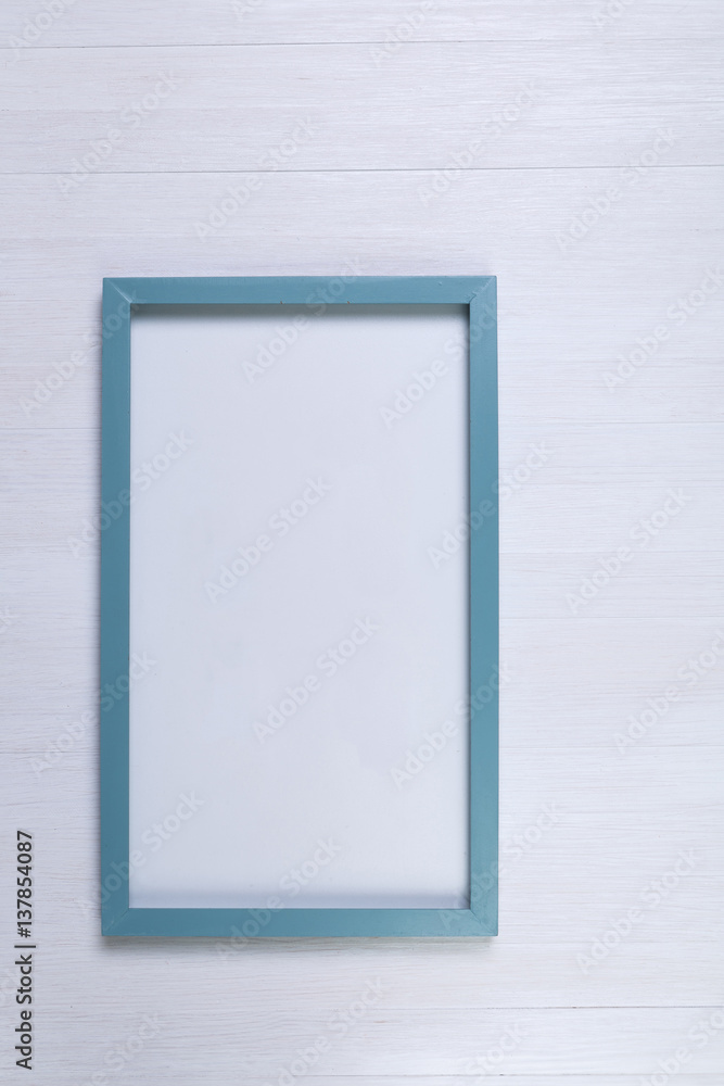 Blank photo frame on white wood background. Painted scraped wooden planks texture or pattern. Blank photo frame on white wood background. Painted scraped wooden planks texture or pattern.