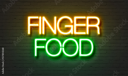 Tela Finger food neon sign on brick wall background.