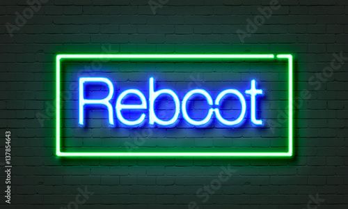 Reboot neon sign on brick wall background. photo