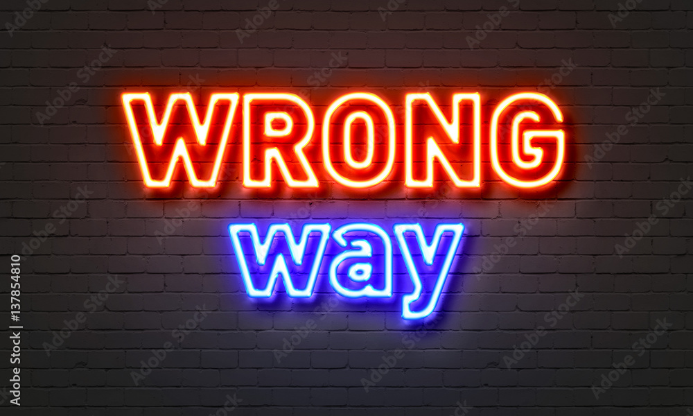 Wrong way neon sign on brick wall background. Wrong way neon sign on brick wall background.