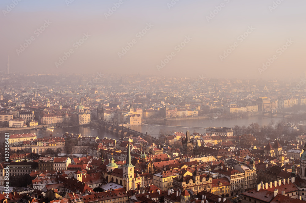 Aerial view to Prague buildings and the city from Prague Castle on a foggy day.