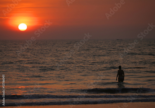 People on the beach at sunset