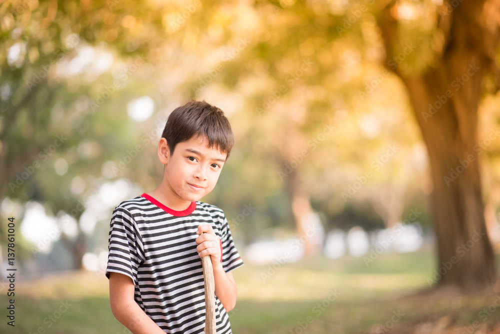 Close up asian boy sitting in th park
