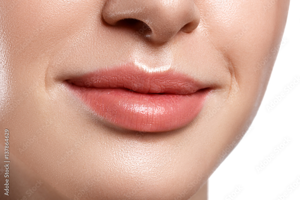Obraz premium Perfect natural lip makeup. Close up macro photo with beautiful female mouth. Plump full lips.