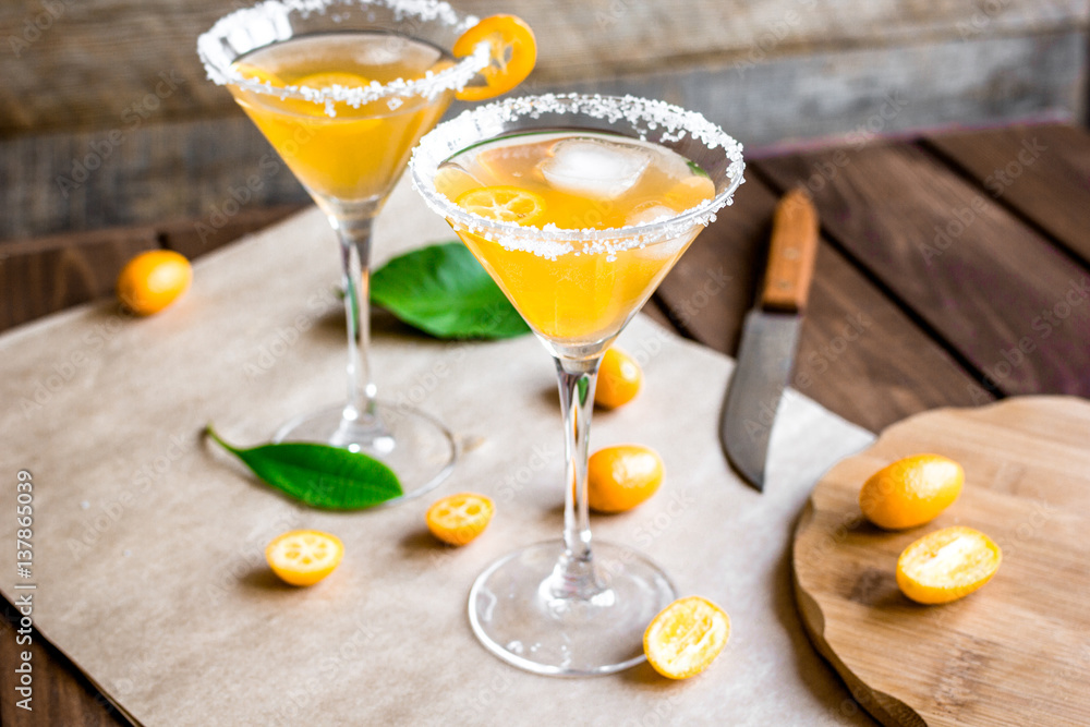 cocktail with kumquat on wooden background cocktail with kumquat on wooden background
