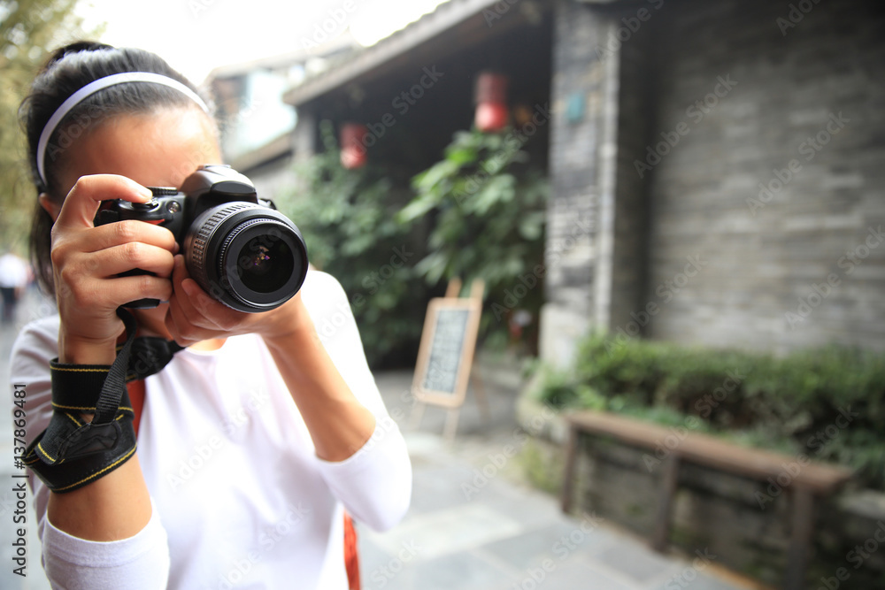 young woman tourist taking photo on street in chengdu,china young woman tourist taking photo on street in chengdu,china