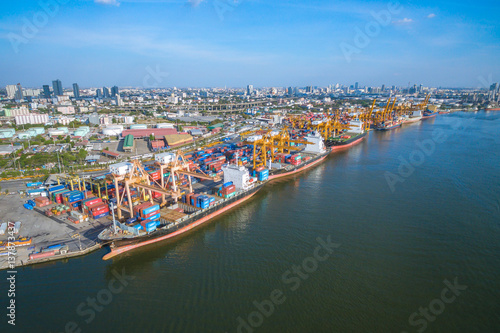 Aerial view container and cargo ship, import export, business logistic supply chain transportation concept and crane at international Port for shipping cargo top view background © FrameAngel
