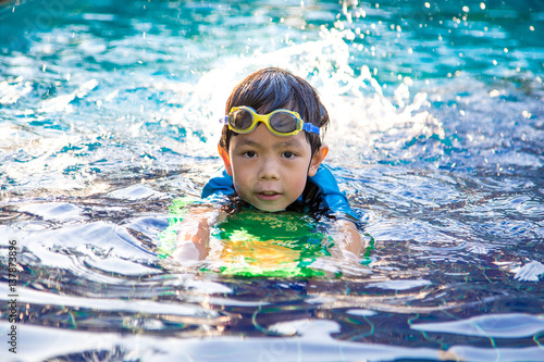 boy learn to swim in the swimming pool