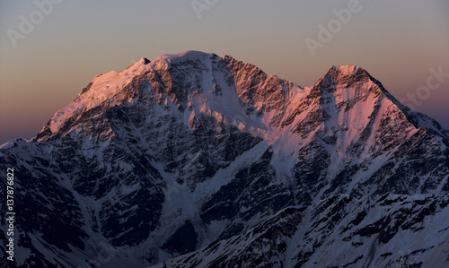First red light on Nakratau (4,269m) (right) and Donguzorun (4,468m) seen from Elbrus, Caucasus, Russia, June 2008