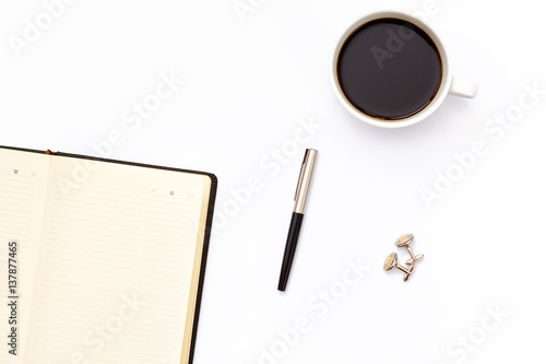 open black diary with pen and Cup of black coffee on a white background