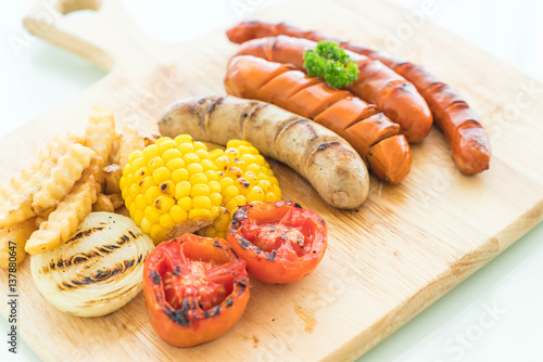 mix grilled sausage with vegetables and french fries