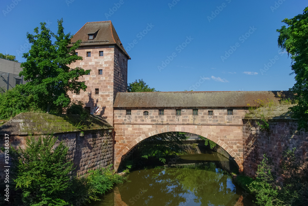 Old city walls with an arch reflected in the Pegnitz river, near Steubenbrucke bridge, historic centre, Nuremberg,  Bavaria, Germany