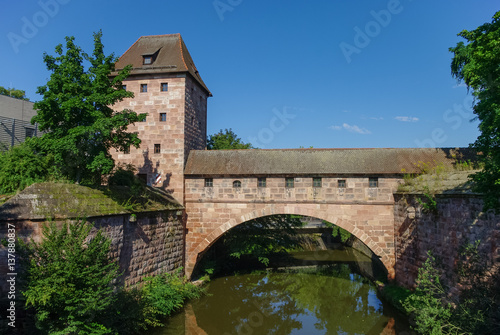 Old city walls with an arch reflected in the Pegnitz river, near Steubenbrucke bridge, historic centre, Nuremberg, Bavaria, Germany