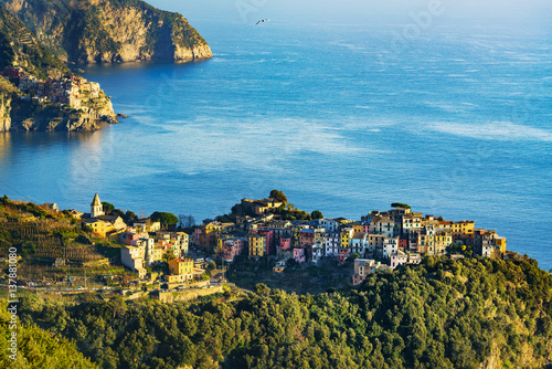 Corniglia village and Manarola in background at sunset. Cinque Terre, Ligury, Italy photo