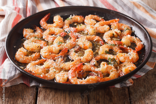 flavorful food: shrimp in garlic sauce with parmesan cheese and herbs closeup. horizontal