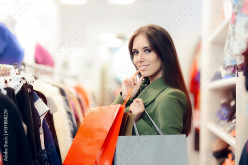 Elegant Shopping Woman Wearing a Green Coat in Fashion Store